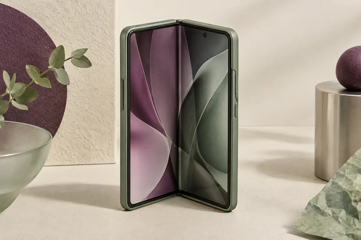 Smartphone pliable au format livre ouvert à moitié et posé debout, écran intérieur visible, dans une coque verte ajustée sur ses deux moitiés
